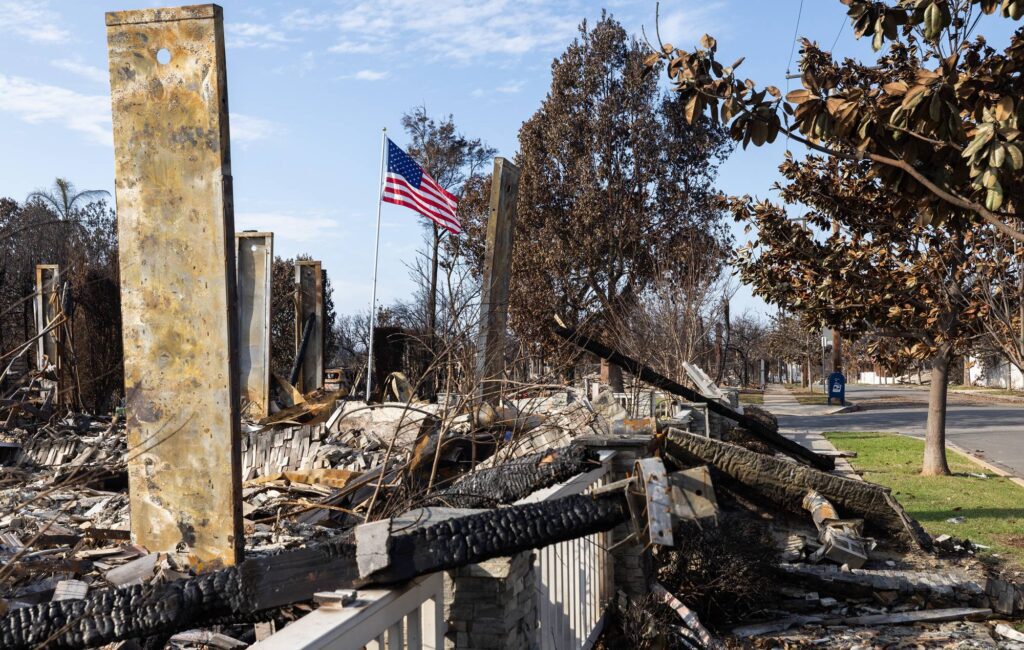 A flag flies at a destroyed house on Galloway Street in Pacific Palisades, CA (Myung J. Chun / Los Angeles Times via Getty Images)