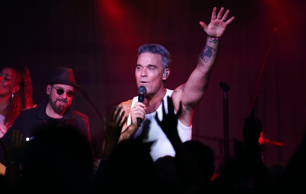 Robbie Williams teases future reunion with Take That: “I’m sure we will ride again”